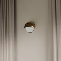 Golden Half Moon Shaped Modern Wall Lamp On Beige Wall With Curtains