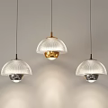 Three Stylish Modern Pendant Lights With Translucent Glass Shades And Metallic Bases