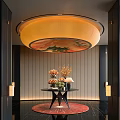 Hotel Lobby Featuring Circular Floral Pattern Ceiling Light Fixture Striped Walls And Flower Arrangements