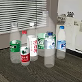 Assorted Bottled Mineral Water Drinks Displayed On Table With Window Background