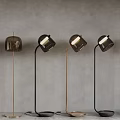 Modern Floor Lamps With Glass Shades And Metal Frames Against Grey Background