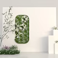 Art Installation With Oval Green Plant Wall White Flowers And Stepped Platforms