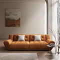 Modern Orange Sofa Set With White Cushions Abstract Wall Art And Books On Side Table