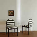 Dining Chairs With Black Metal Frames And Black White Striped Cushions Against Light Colored Walls