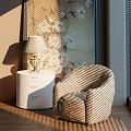 Striped Accent Leisure Chair With White Nightstand Table Lamp Floral Painting And Sunlight Shadows