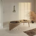 Modern Curved Wooden Coffee Table In Warm Sunlight With Decorative Plant And Side Table