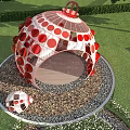 Red Spherical Art Installation In Outdoor Garden With Trees And Flowers