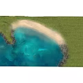 Scenic Coastal Landscape With Green Grass Sandy Beach And Clear Blue Water