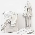 White Washing Machine With Freshly Laundered Soft Towels And Hanging Robes