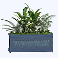 Blue Garden Planter With Diamond Pattern And Various Green Plants Including Large Leaves And Ferns