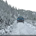 Snowy Mountain Road Scenery With Blue Jeep Snow Covered Trees Under Clear Blue Sky