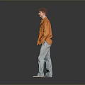 A Man Standing In Gray Background Wearing Orange Jacket Blue T-shirt And Light Blue Jeans