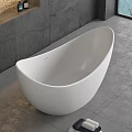 Modern White Freestanding Bathtub In Bathroom With Grey Walls And Towels
