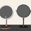 Round Tabletop Vanity Mirrors With Pink And Silver Bases And Illuminated Circular Design