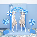 Dreamy Candy Pop-up Store With Models In Beige Dresses And Blue White Lollipop Decorations