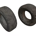 Two Worn Rubber Tires With Deep Tread Patterns And Weathered Surface