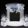 White Mesh Wedding Ceremony Arch With Blue White Flowers Yellow Lights And Round Platform