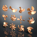 Multiple Brass Propellers With Different Blade Designs Arranged On Dark Surface