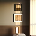 Abstract Painting With Warm Hues In Black Frame Hanging On Wall With Sunlight Streaks