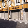 Modern Commercial Street With Wooden Storefronts Playboy Signboards And Glass Windows