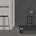 Poliform Modern Bar Stools With Black Seat And Wooden Backrest Against Gray Wall And Golden Column
