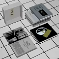 Stacked Books And Open Magazine With Black White Photos Geometric Designs On White Tiled Background