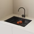 Modern Kitchen Sink With Black Faucet Running Water And Orange Fruits In White Countertop