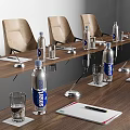 Wooden Conference Table With Multiple Chairs Water Bottles And Power Outlets On Wall Panel