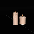 Two Lit Cream Colored Candles With Melting Wax On Black Background