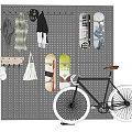 Gray Perforated Pegboard Wall Hanging Umbrella Coats Scarves Skateboards Small Shelf and Black Bicycle