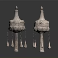 Two Traditional Sculptural Carvings With Ornate Tops Intricate Patterns And Hanging Tassels