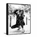 Fashionable Woman in Black Leather Crouching Taking Photo Street Portrait with Streetlights and Trees