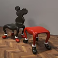 Mickey Shaped Black And Red Leisure Chairs With White Decorated Legs On Wooden Floor