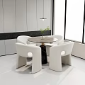 Modern Round Dining Table And White Chairs Set With Green Plant Vase In Indoor Room