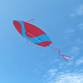 Colorful Blue And Red Kite Flying High In Clear Blue Sky With Clouds