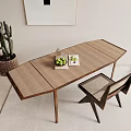 Wooden Desk With Woven Surface Chair Green Fruits Glass Bottle Magazine Cactus And Wall Art