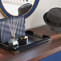 Elegant Decorative Ornament Set With Tray Diffuser Candle Jar On Wooden Tabletop And Blue Cabinets