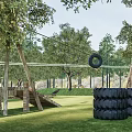 Natural Children's Play Area With Grassland Tree Stumps Kids Playing Surrounded By Trees