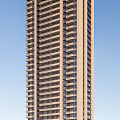 Modern High Rise Residential Building With Trees Other Structures And Sunny Sky