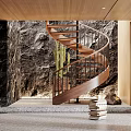 Wooden Spiral Staircase With Metal Railings Rock Wall Cactus Plant And Stack of Books Nearby
