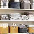 Storage Shelf Unit with Folded Towels Baskets Laundry Sign and Potted Plant