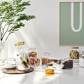 Stylish Ceramic Vessels On Kitchen Counter With Glass Jars Colorful Candies And Green Plants