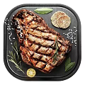 Grilled Steak On Black Plate With Rosemary Lemon Slices And Salt