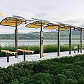 Outdoor Fitness Area With Solar Powered Bus Stop Benches Waterfront Greenery Pathway
