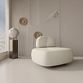 Modern Minimalist Beige Single Sofa in Bright Room with Globe Decor and Round Wall Art