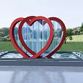 Red Double Heart Sculpture in Water Pool with Green Grass and Trees
