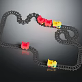 Toy Train Tracks With Curved Black Rails And Multiple Red Yellow Blue Carriages