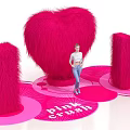 Vibrant Pink Crush Display With Heart Shape I U Plush Decorations And Person