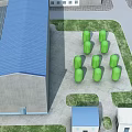 Industrial Factory Building With Blue Roof Green Cylindrical Storage Tanks And Surrounding Grassland Pathways