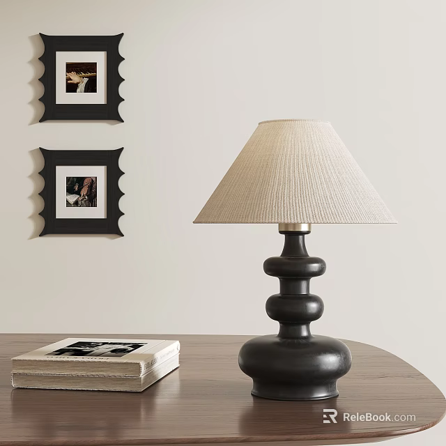 Modern Table Lamp Featuring Black Base Beige Lampshade On Wooden Table With Books And Frames 3d model 
